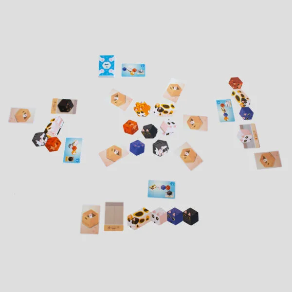 Example of Kitty Paw in action, with players racing to arrange kitten tiles to match patterns on their Kitty cards.