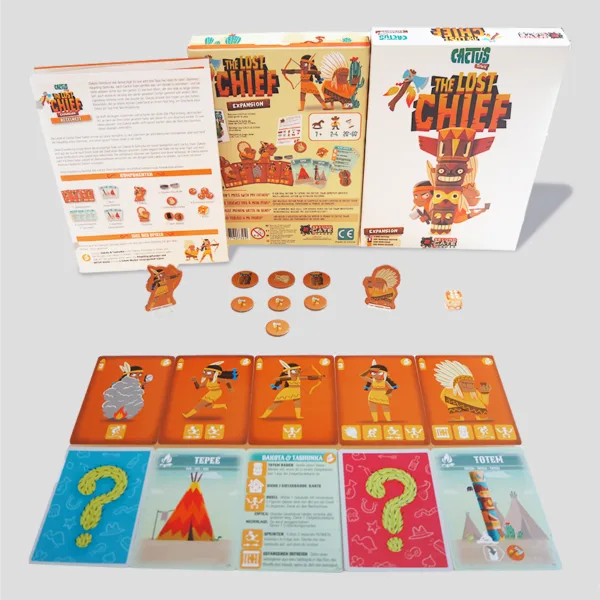 All materials from The Lost Chief Expansion laid out, including character standees, action cards, town tiles, and tokens for asymmetric gameplay.