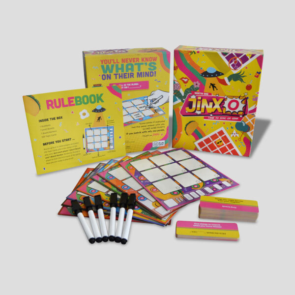 All components of JinxO laid out (cards, score sheets, rulebook, etc.).