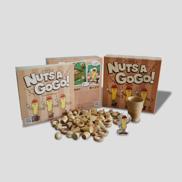 All components of Nuts a GoGo! laid out (game pieces, stash boards, rulebook, etc.).